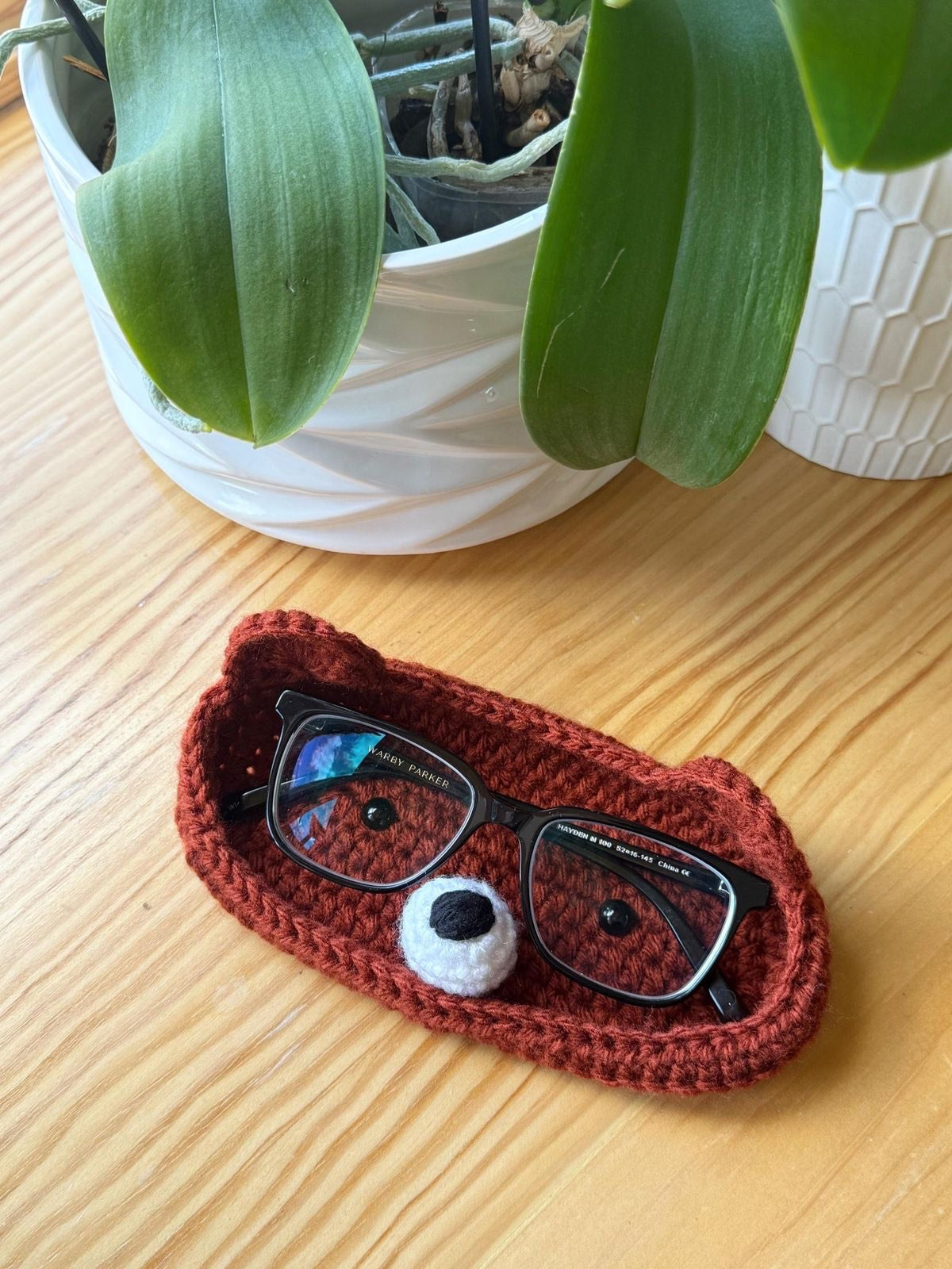 brown bear design of a crochet holder for glasses